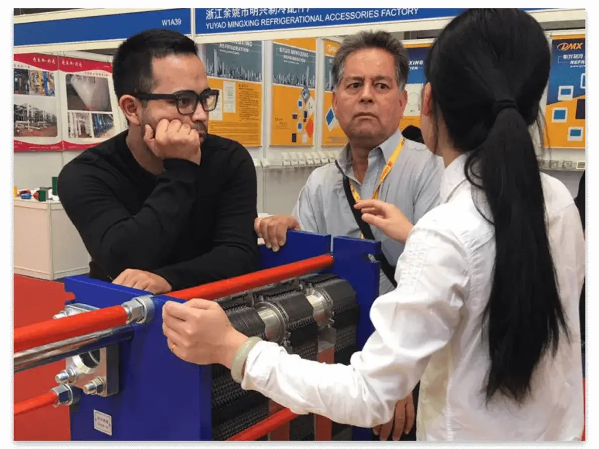 Technical discussion with clients at plate heat exchanger display